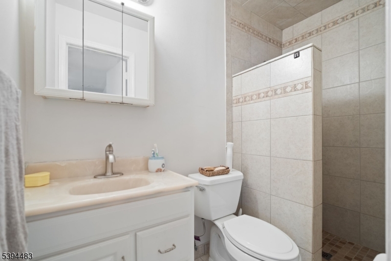 919 Robin Road Hillsborough, NJ 08844 - Photo 11 of 21 a bathroom with a sink a toilet and mirror