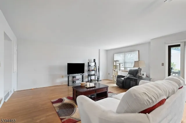 a living room with furniture ceiling fan and a window