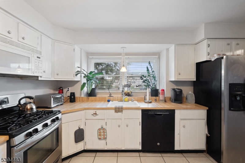 919 Robin Road Hillsborough, NJ 08844 - Photo 17 of 21 a kitchen with a sink a stove and refrigerator