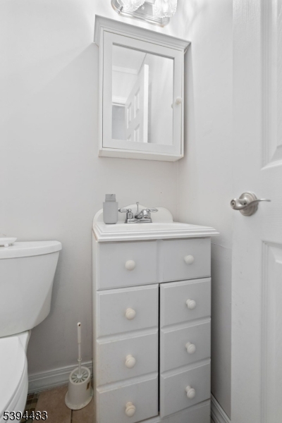 919 Robin Road Hillsborough, NJ 08844 - Photo 19 of 21 a bathroom with a toilet sink and mirror