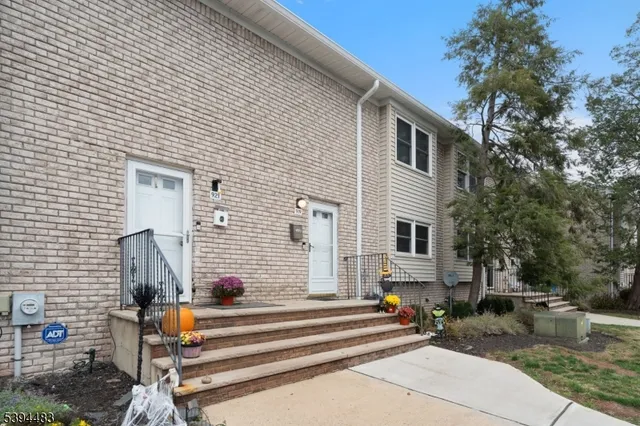 a front view of a house with outdoor seating