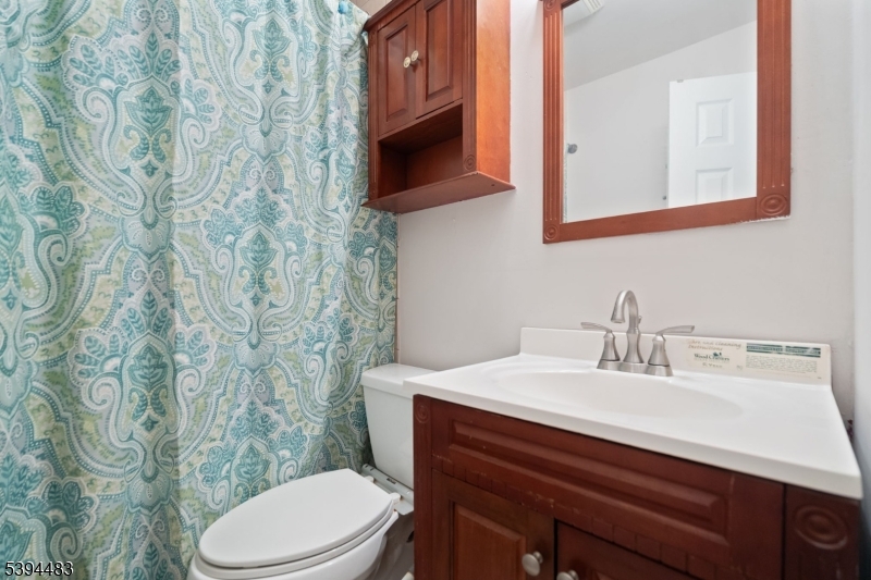 919 Robin Road Hillsborough, NJ 08844 - Photo 8 of 21 a bathroom with a sink a toilet and a mirror