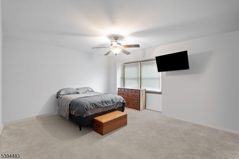 919 Robin Road Hillsborough, NJ 08844 - Photo 10 of 21 a living room with furniture and a flat screen tv