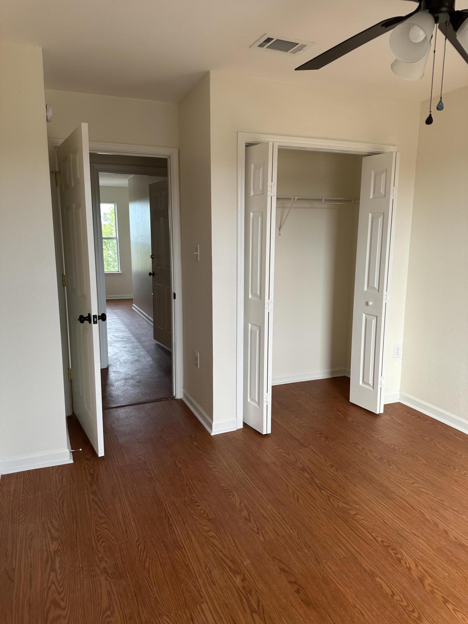 1150 Airport Road, Unit 138 Destin, FL 32541 - Photo 11 of 16 an empty room with wooden floor and a bathroom