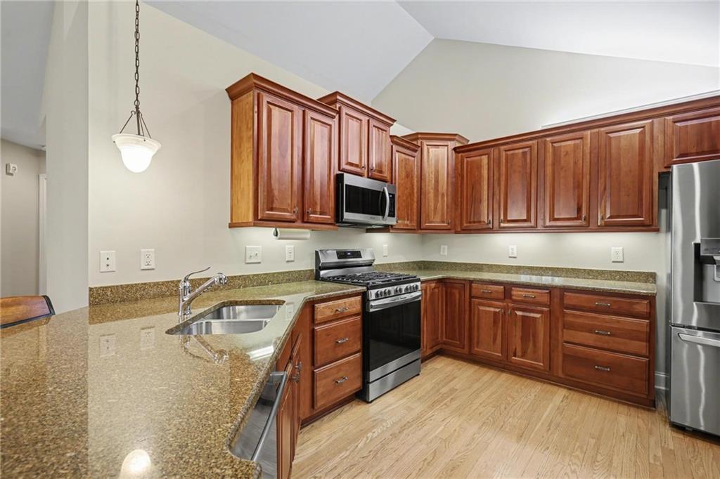 214 Highlands Ridge Place, Unit 3 Smyrna, GA 30082 - Photo 14 of 25 a kitchen with stainless steel appliances granite countertop a sink stove and microwave