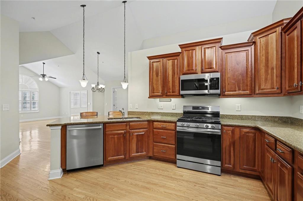 214 Highlands Ridge Place, Unit 3 Smyrna, GA 30082 - Photo 15 of 25 a kitchen with stainless steel appliances granite countertop a stove top oven a sink dishwasher and a refrigerator