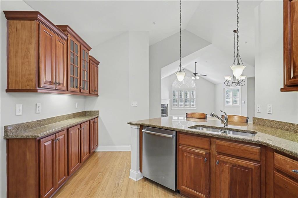 214 Highlands Ridge Place, Unit 3 Smyrna, GA 30082 - Photo 16 of 25 a kitchen with stainless steel appliances granite countertop a sink a counter space cabinets and wooden floor