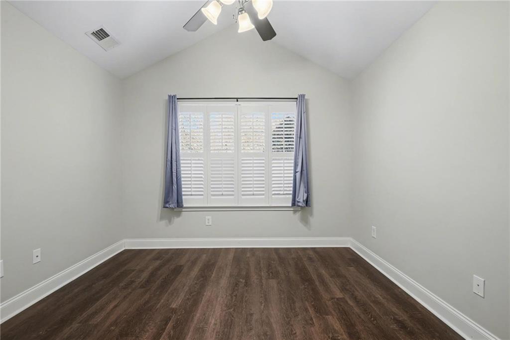 214 Highlands Ridge Place, Unit 3 Smyrna, GA 30082 - Photo 20 of 25 an empty room with wooden floor exposed radiator and windows