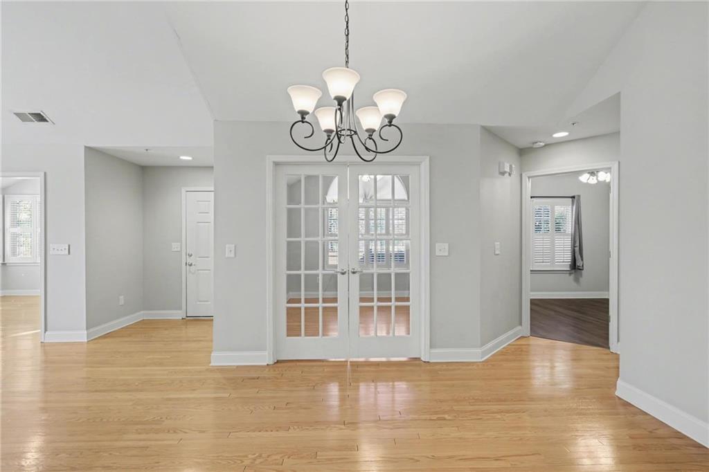 214 Highlands Ridge Place, Unit 3 Smyrna, GA 30082 - Photo 5 of 25 a view of an empty room with wooden floor and windows