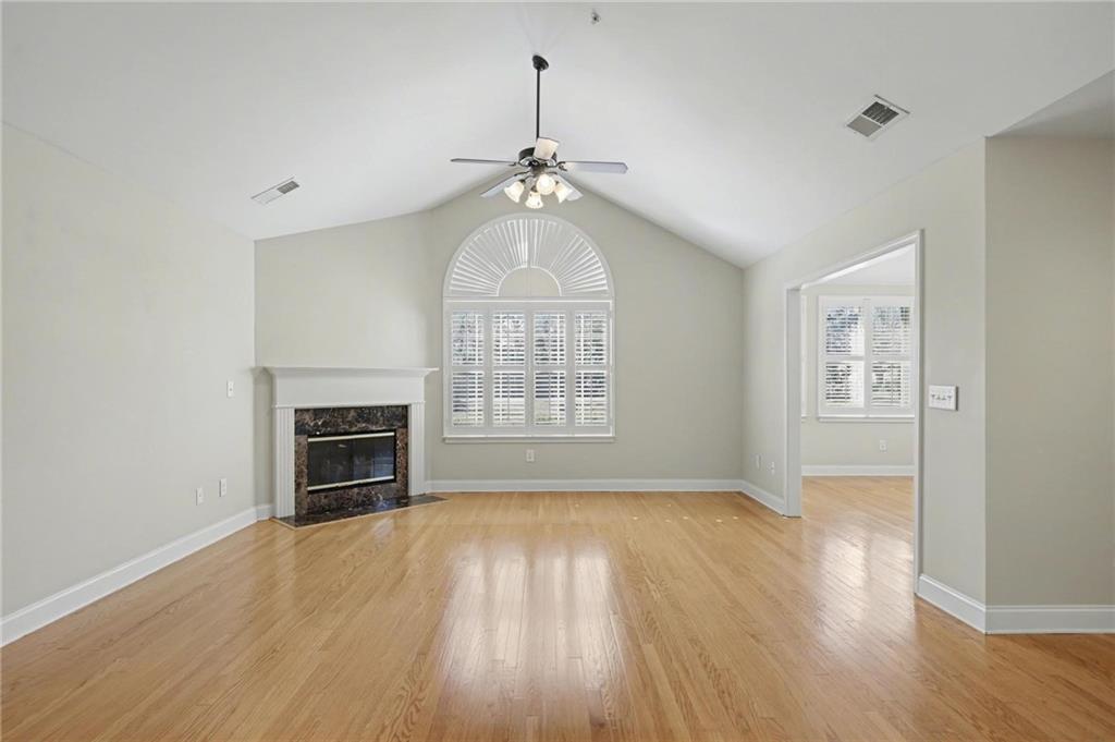 214 Highlands Ridge Place, Unit 3 Smyrna, GA 30082 - Photo 6 of 25 a view of empty room with wooden floor fireplace and a window
