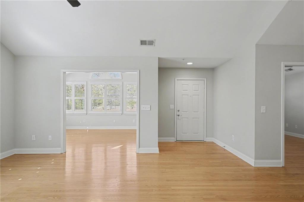 214 Highlands Ridge Place, Unit 3 Smyrna, GA 30082 - Photo 9 of 25 a view of an empty room with wooden floor and a window