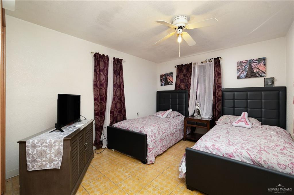 264 West Huisache Street Rio Grande City, TX 78582 - Photo 11 of 16 a bedroom with bed and flat tv screen on dresser