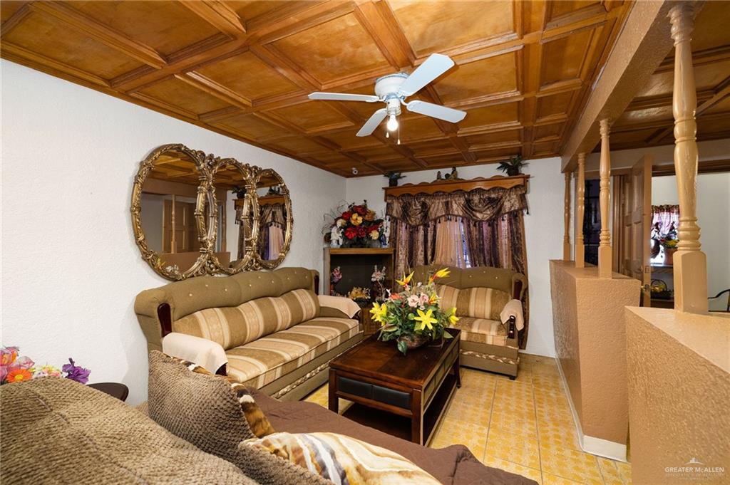 264 West Huisache Street Rio Grande City, TX 78582 - Photo 5 of 16 a living room with furniture and flowers