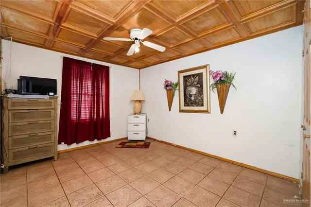 a bedroom with bed and flat tv screen on dresser