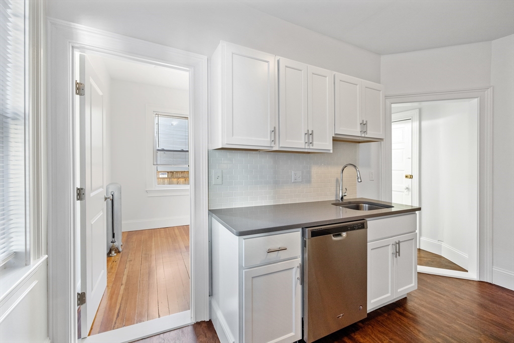 122 Columbia Street, Unit 3 Cambridge, MA 02139 - Photo 12 of 17 a kitchen with stainless steel appliances granite countertop a sink and a stove with white countertops
