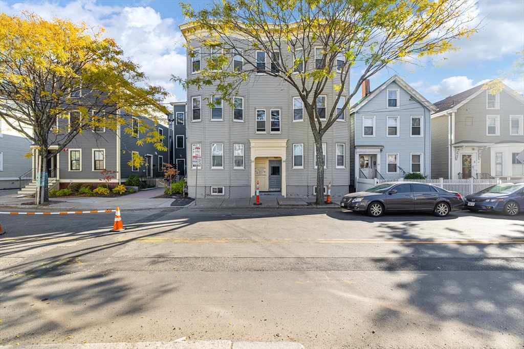 122 Columbia Street, Unit 3 Cambridge, MA 02139 - Photo 16 of 17 a view of a city street lined with buildings and trees