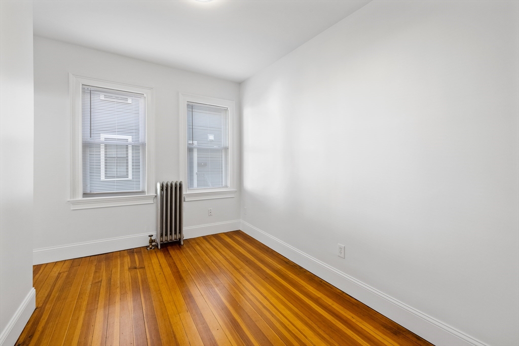 122 Columbia Street, Unit 3 Cambridge, MA 02139 - Photo 2 of 17 a view of empty room with wooden floor and fan