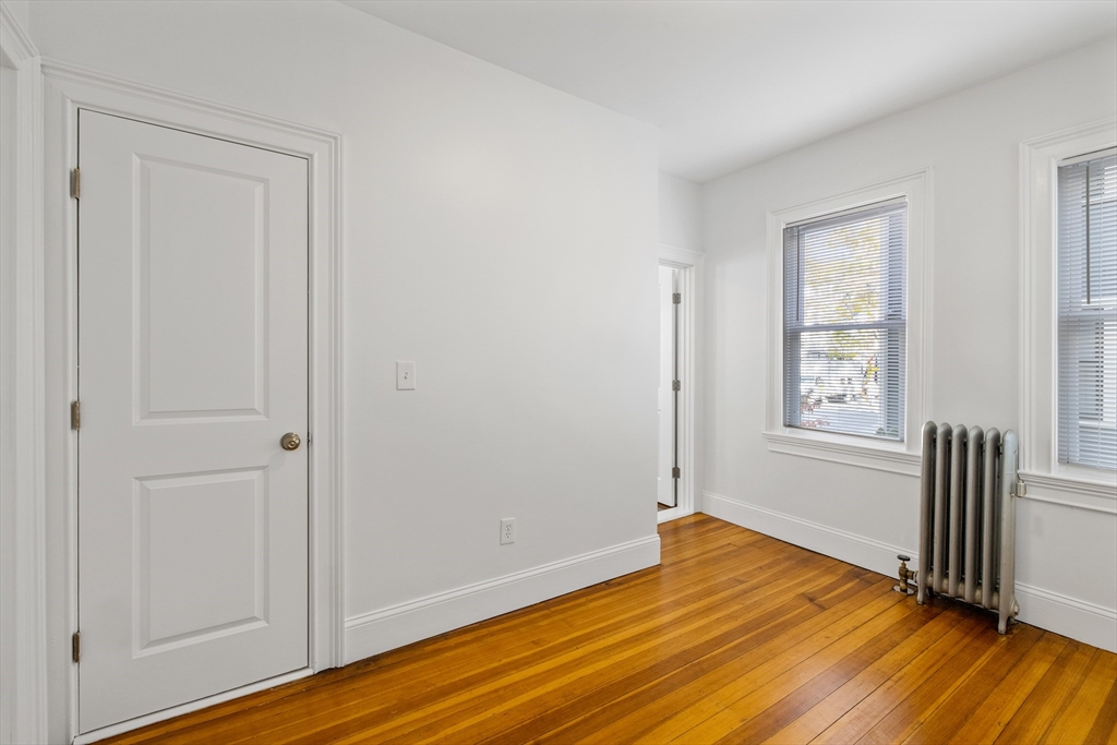 122 Columbia Street, Unit 3 Cambridge, MA 02139 - Photo 5 of 17 a view of empty room with wooden floor and fan