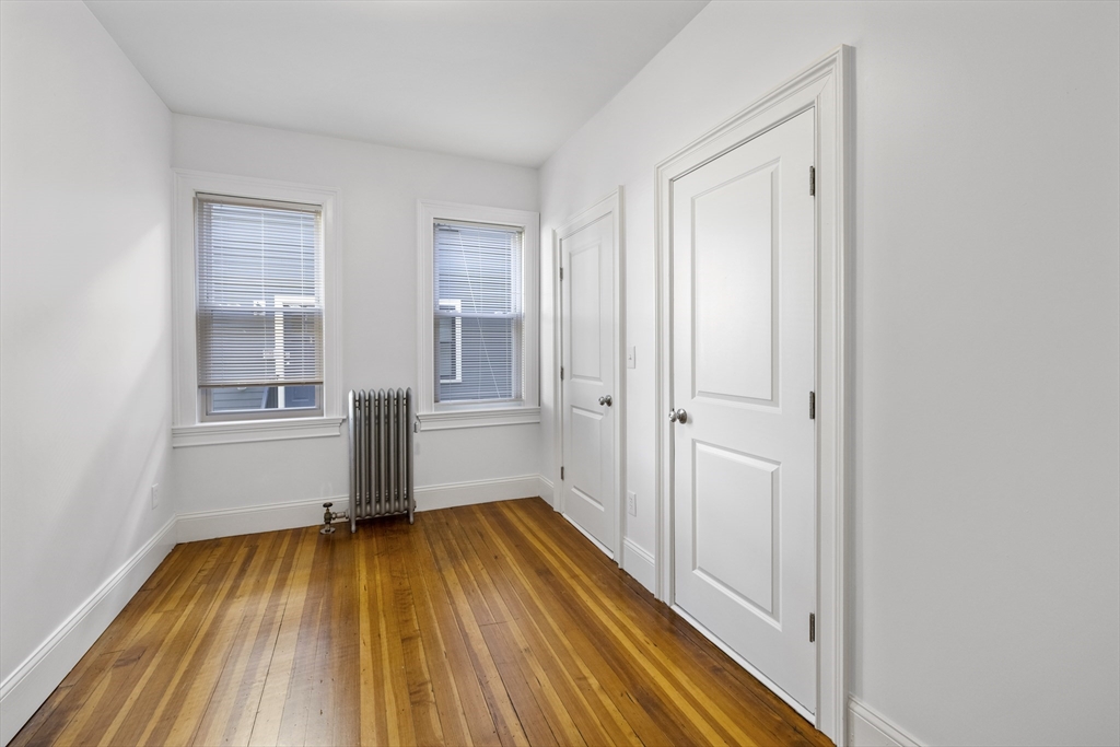 122 Columbia Street, Unit 3 Cambridge, MA 02139 - Photo 8 of 17 a view of a room with wooden floor and a window