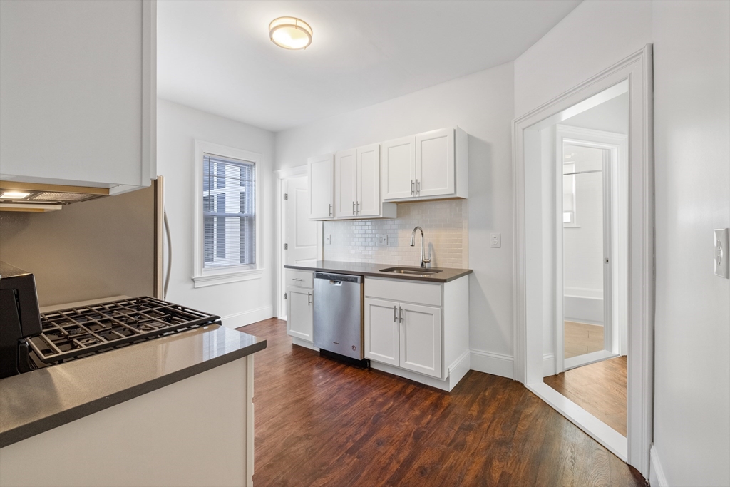 122 Columbia Street, Unit 3 Cambridge, MA 02139 - Photo 10 of 17 a kitchen with granite countertop a stove and a sink