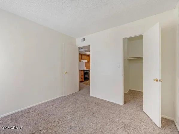 a view of an empty room and closet