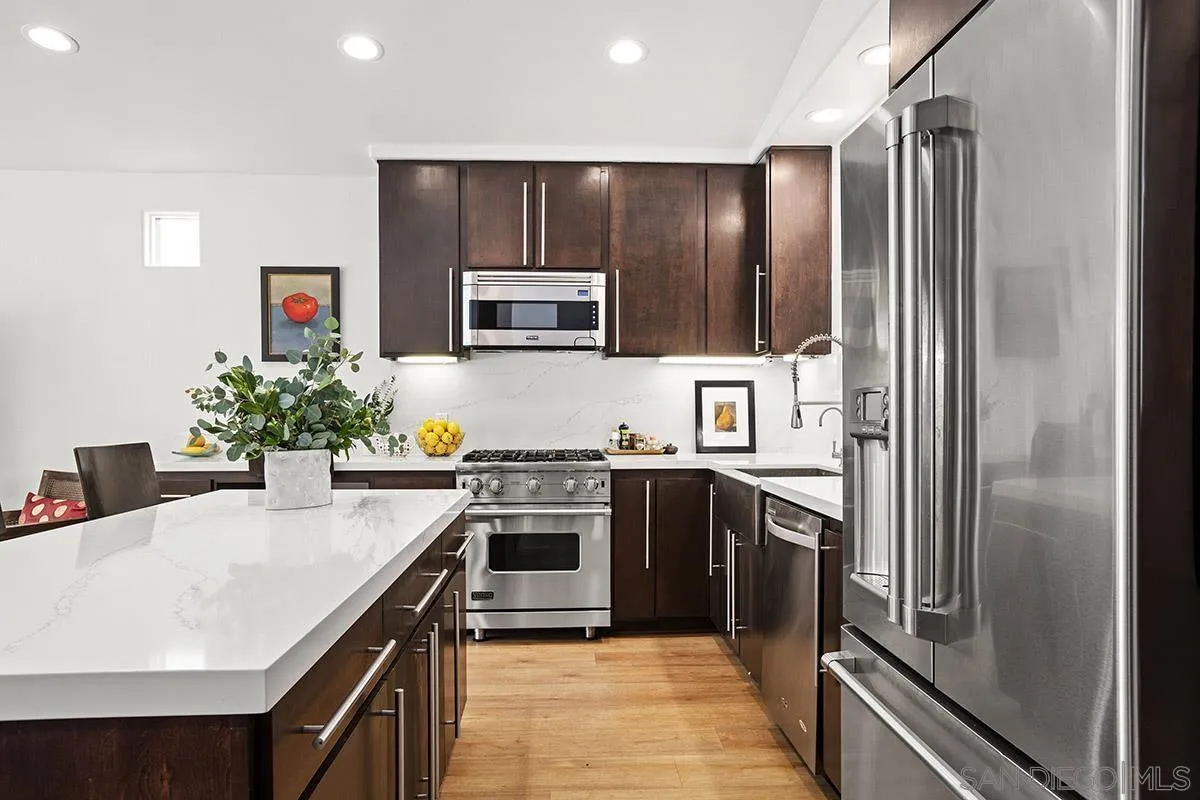 3433 Alabama Street San Diego, CA 92104 - Photo 17 of 58 a kitchen with kitchen island granite countertop stainless steel appliances and sink