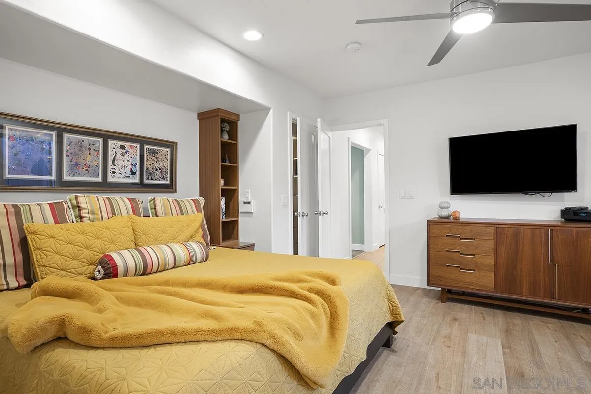 3433 Alabama Street San Diego, CA 92104 - Photo 26 of 58 a bedroom with a large bed and a flat screen tv