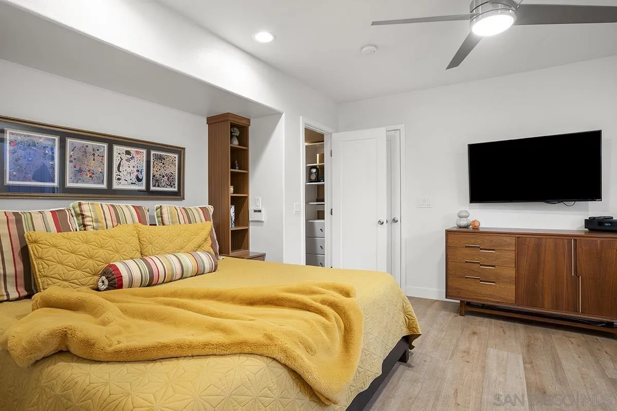 3433 Alabama Street San Diego, CA 92104 - Photo 27 of 58 a bedroom with a large bed and a flat screen tv