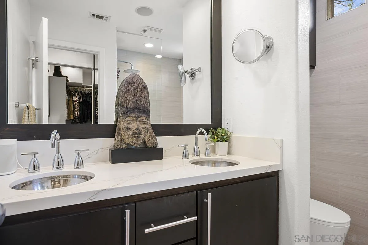 3433 Alabama Street San Diego, CA 92104 - Photo 30 of 58 a bathroom with a double vanity sink and a mirror