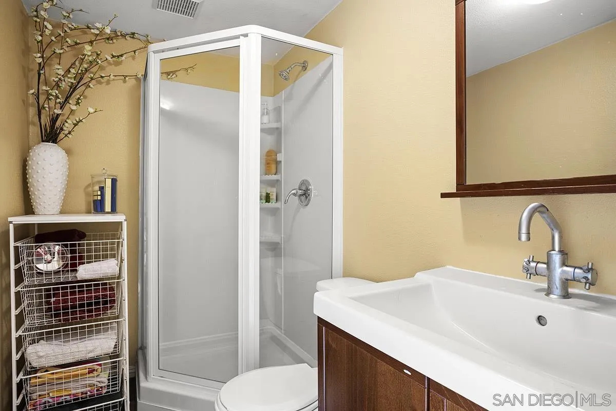 3433 Alabama Street San Diego, CA 92104 - Photo 56 of 58 a bathroom with a sink and a mirror