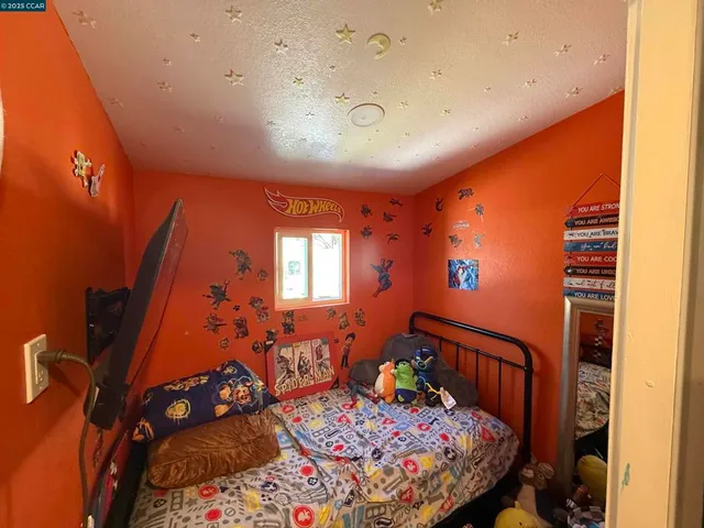 a bedroom with furniture and a window