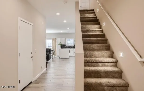 a view of entryway and hall with wooden floor