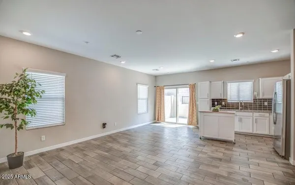 a kitchen with white cabinets and a refrigerator