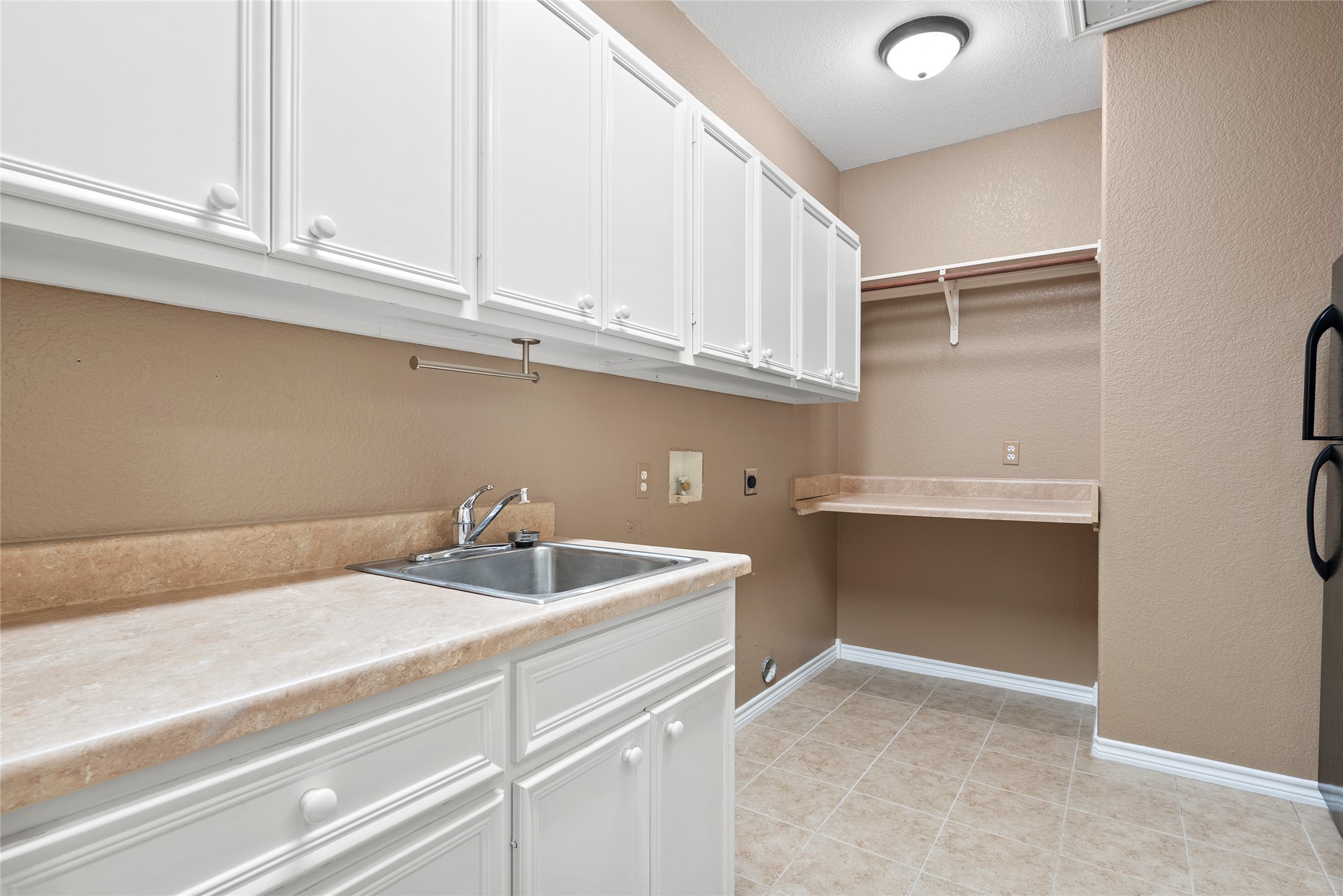 330 Arbors Circle Elgin, TX 78621 - Photo 12 of 37 Washroom with lots of storage and featuring a sink, washer hookup, hookup for an electric dryer, baseboards, and cabinet space