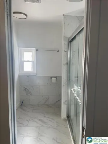 a bathroom with a granite countertop shower