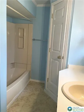 a bathroom with a tub and a sink