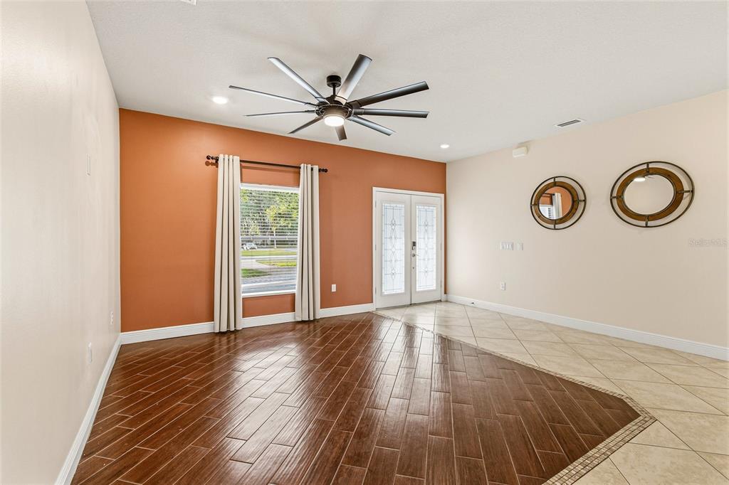 4821 Falcon Boulevard Cocoa, FL 32927 - Photo 12 of 48 a view of an empty room with wooden floor and window