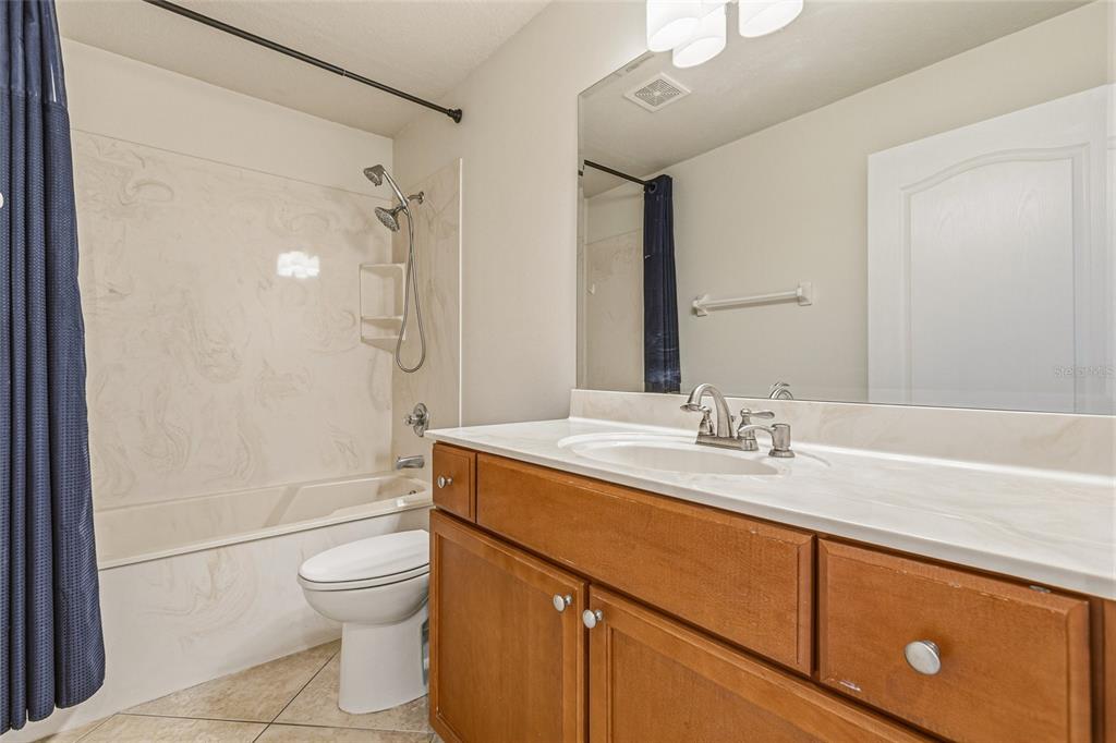 4821 Falcon Boulevard Cocoa, FL 32927 - Photo 26 of 48 a bathroom with a granite countertop sink toilet and shower