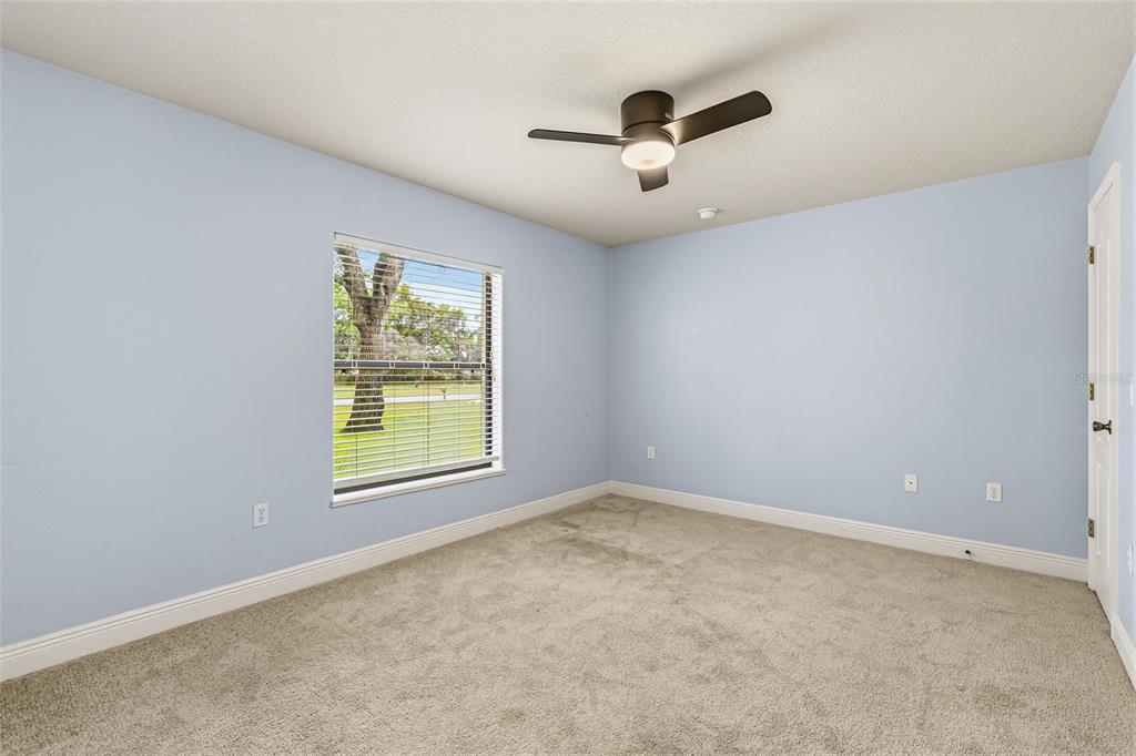 4821 Falcon Boulevard Cocoa, FL 32927 - Photo 28 of 48 an empty room with windows and fan view