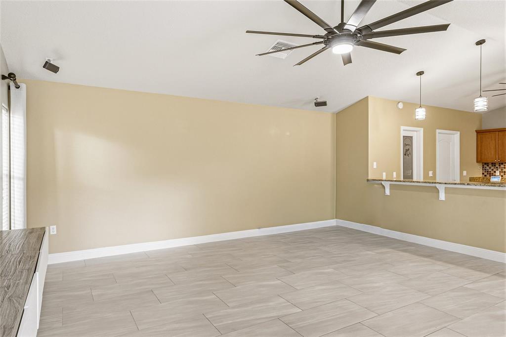4821 Falcon Boulevard Cocoa, FL 32927 - Photo 32 of 48 an empty room with windows and fan