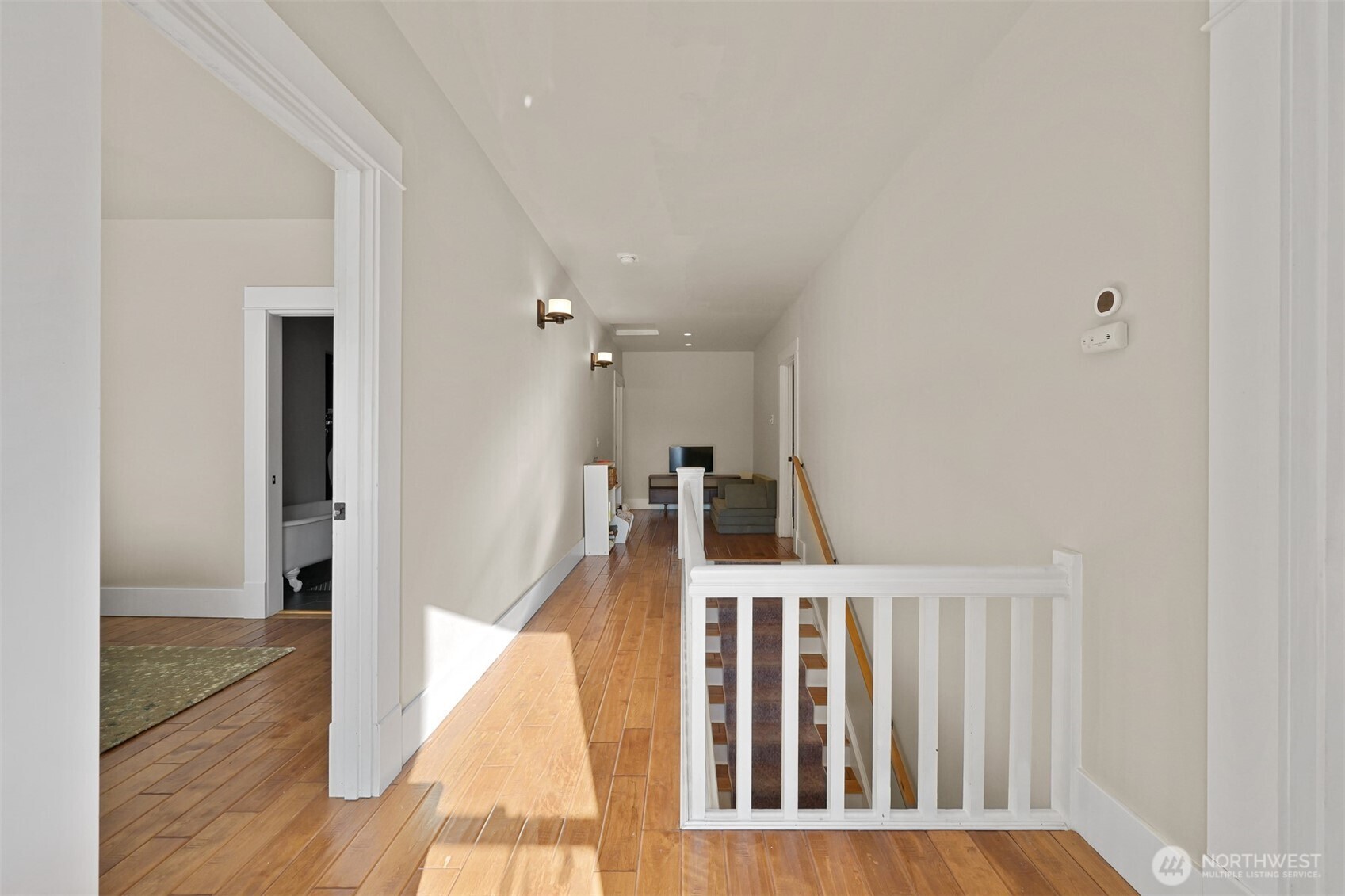 2880 Creasey Road Custer, WA 98240 - Photo 25 of 40 a view of a hallway with white walls and wooden floor