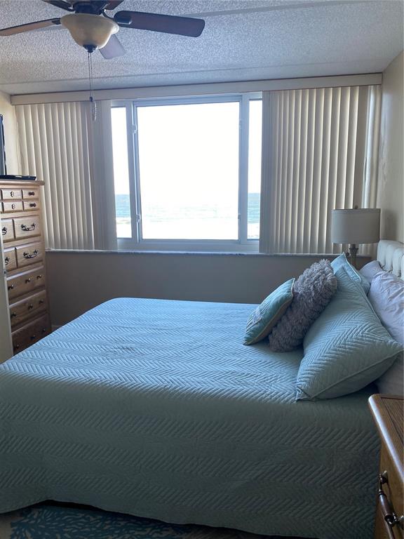 4453 South Atlantic Avenue, Unit 208 Ponce Inlet, FL 32127 - Photo 23 of 40 a bed sitting in a bedroom next to a window