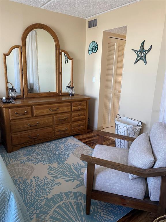 4453 South Atlantic Avenue, Unit 208 Ponce Inlet, FL 32127 - Photo 26 of 40 a bedroom with a bed and a dresser