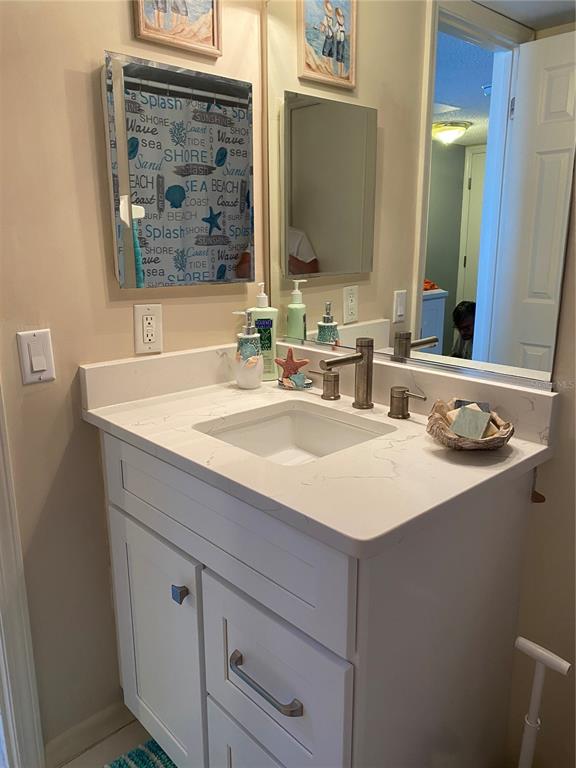 4453 South Atlantic Avenue, Unit 208 Ponce Inlet, FL 32127 - Photo 29 of 40 a bathroom with a sink and a mirror