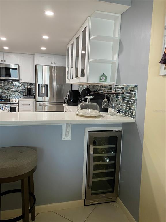 4453 South Atlantic Avenue, Unit 208 Ponce Inlet, FL 32127 - Photo 32 of 40 a kitchen with stainless steel appliances granite countertop a sink stove and cabinets