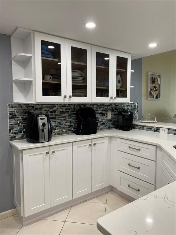 4453 South Atlantic Avenue, Unit 208 Ponce Inlet, FL 32127 - Photo 39 of 40 a kitchen with stainless steel appliances kitchen island granite countertop a sink and cabinets