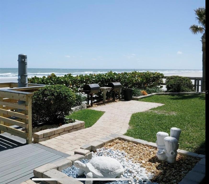 4453 South Atlantic Avenue, Unit 208 Ponce Inlet, FL 32127 - Photo 4 of 40 a view of a patio with a table and chairs
