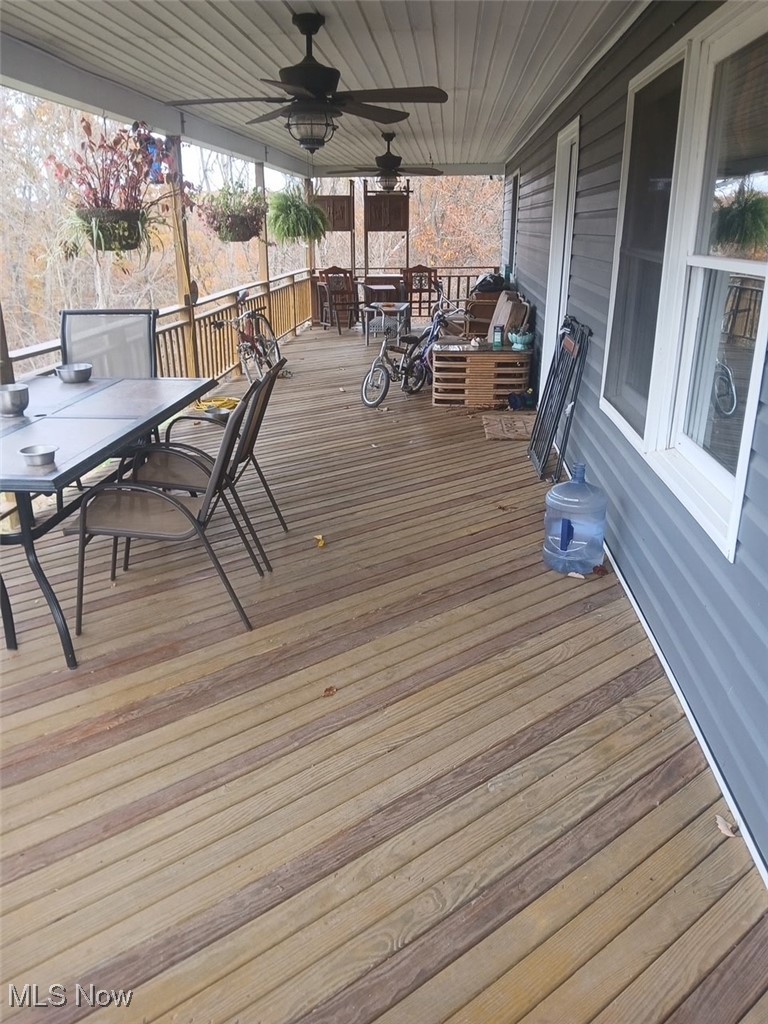 1685 Fattler Ridge Road Philo, OH 43771 - Photo 17 of 24 Wooden deck with outdoor dining space and ceiling fan