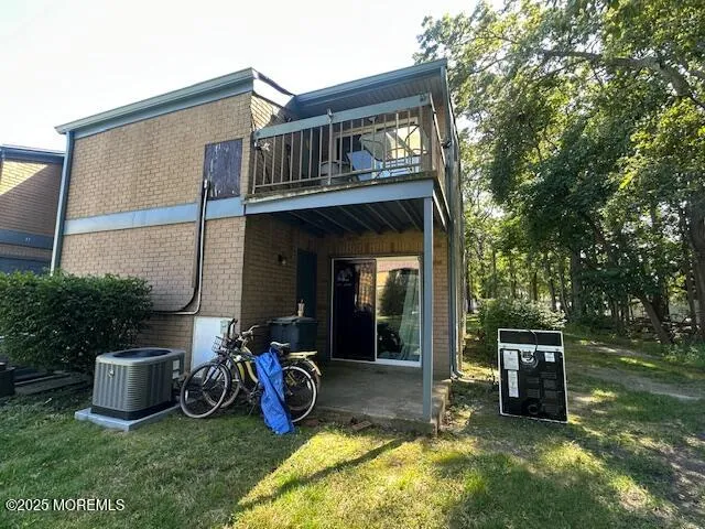 a view of a chair and table in backyard of the house
