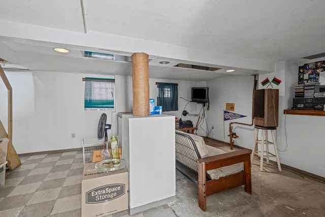 a living room with furniture a flat screen tv and a table